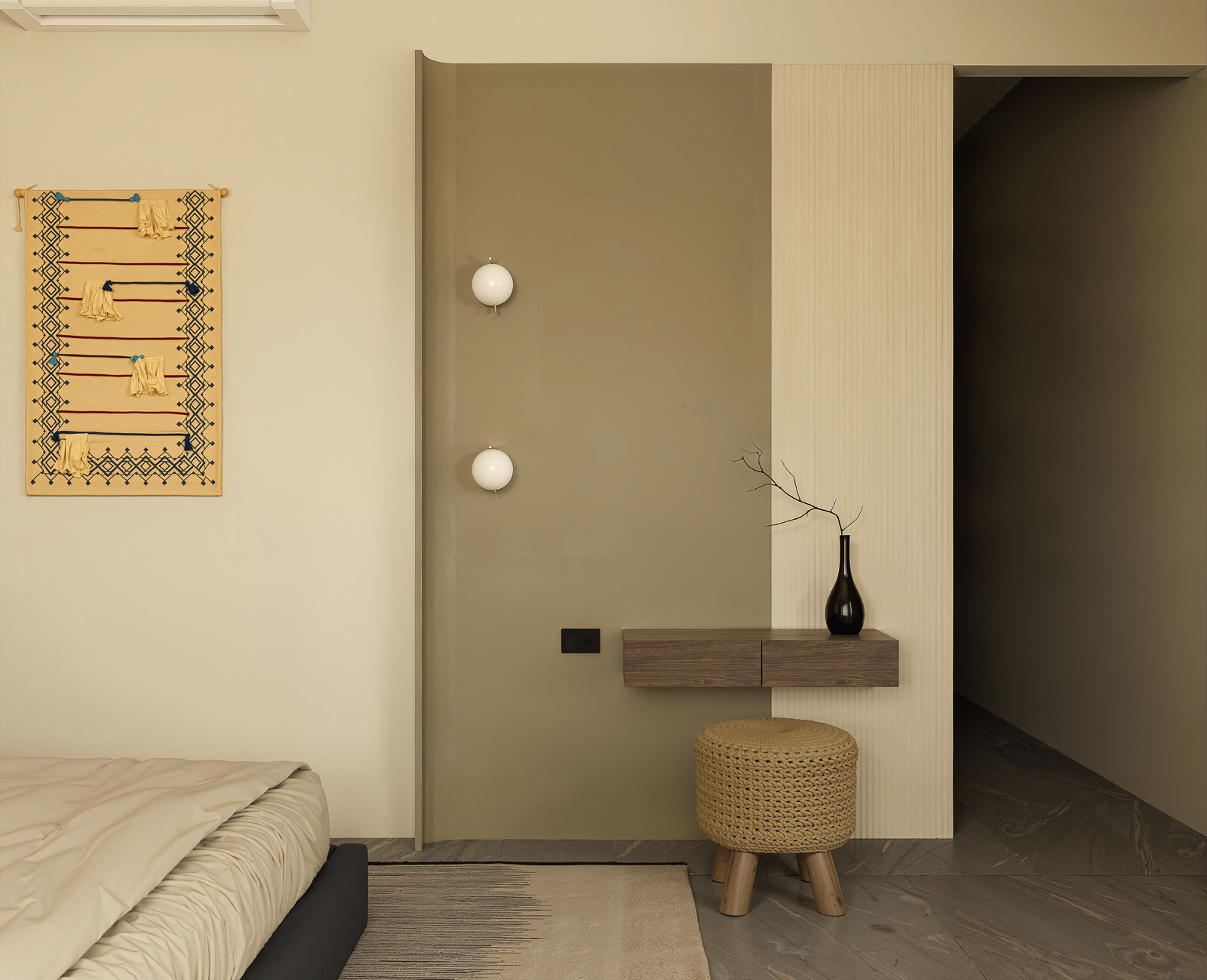 Bedroom corner with woven wall tapestry, olive accent wall and knit stool
